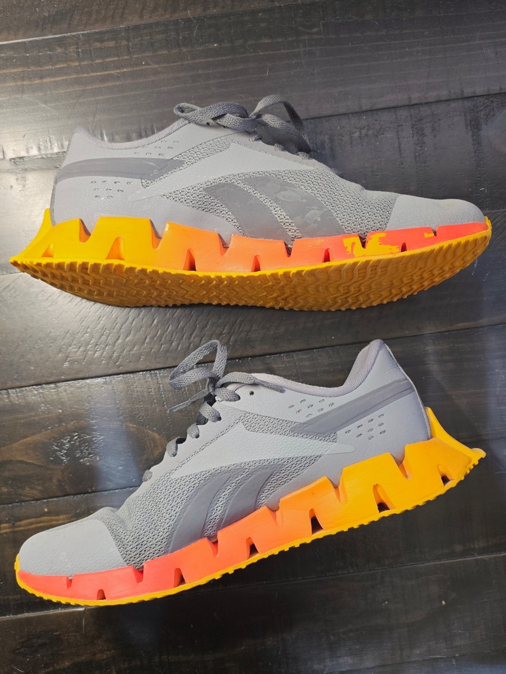 Reebok Grey Mesh Sneakers with Orange-Yellow Gradient Sole